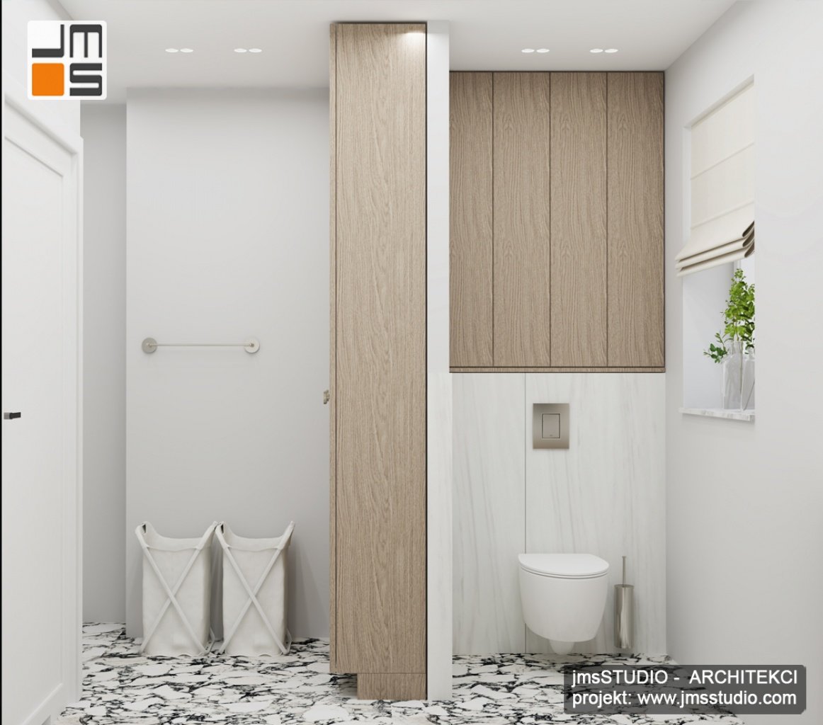 Projekt wnętrz łazienki zakładał stworzenie prostego i funkcjonalnego wnętrza w jasnych kolorach ocieplonego drewnem 
