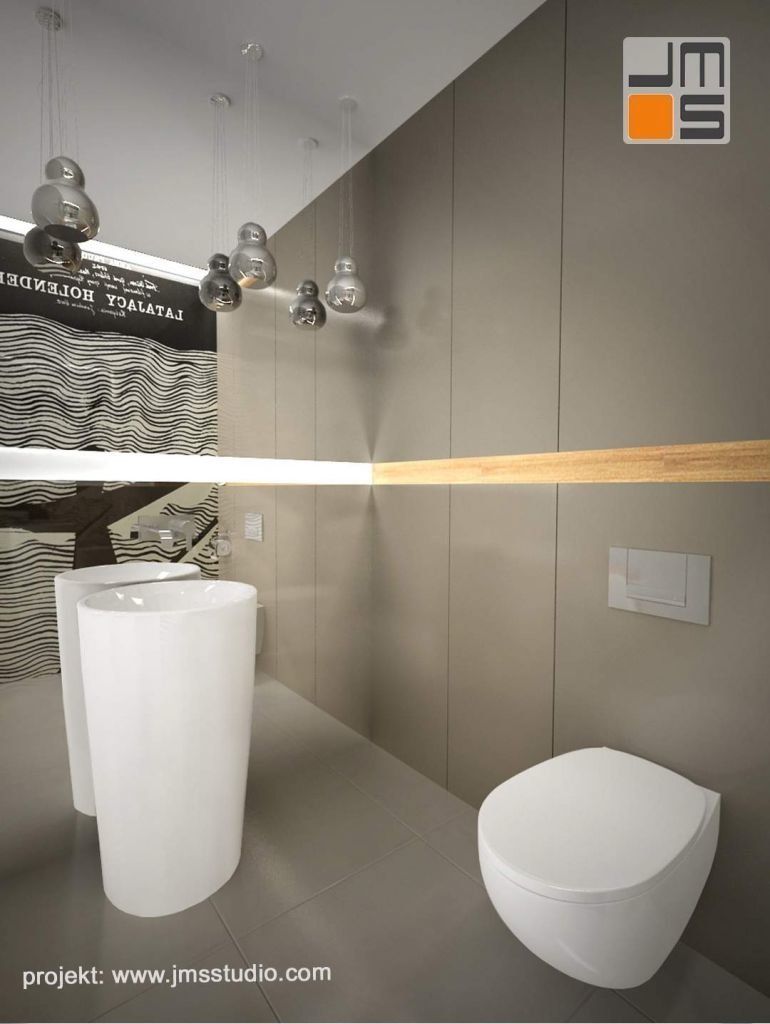 W projekcie ekskluzywnej łazienki z dużym plakatem zastosowano umywalkę wolnostojącą i stonowaną kolorystykę