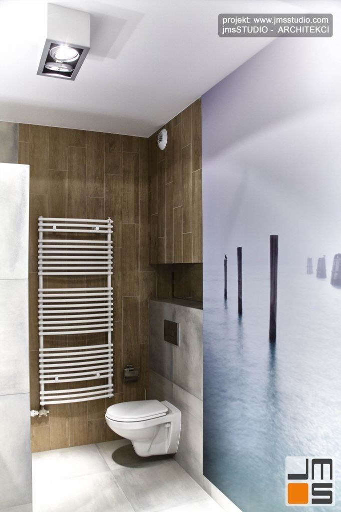 Projekt łazienki z dużą grafiką w kolorach turkusu z motywem morskim - falochron wydrukowano na tapecie firmy VESTIGE z Krakowa
